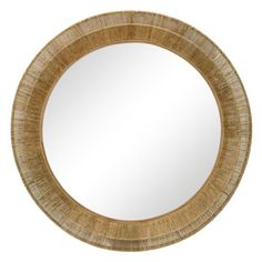 a round mirror that is made out of wood and has a rattan pattern on it