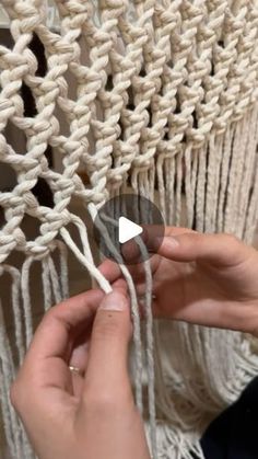 someone is working with yarn on a macrame wall hanging or hammock