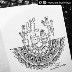 a drawing of cactuses and cacti in pots on top of a computer keyboard