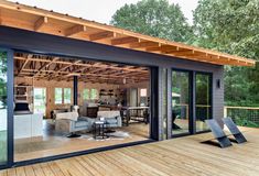 an open concept living room and dining area with sliding glass doors on the outside wall