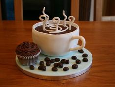 there is a cupcake on the table with coffee beans