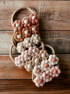 crocheted purses are hanging on a wooden wall with yarn balls all over them