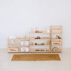 a wooden shelf filled with toys on top of a white floor next to a rug