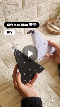 someone is holding an origami boat with hearts on it and the text gift box idea diy