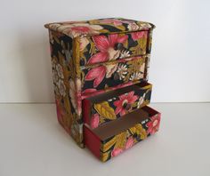 this is an image of a flowered box with drawers on it's sides