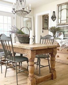 a dining room table with chairs and a chandelier