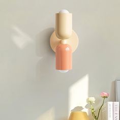 two vases and a lamp on a white wall