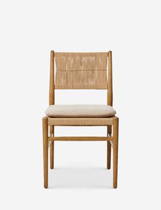 a wooden chair with a beige seat and back cushion on the side, against a white background