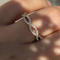 a woman's hand with a diamond ring on it