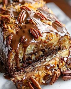 there is a piece of cake with pecans on it and chocolate drizzle