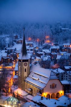 the town is covered in snow at night