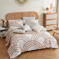 a bed with white and brown comforters in a bedroom