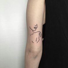 a woman's arm with a small tattoo on the left side of her arm