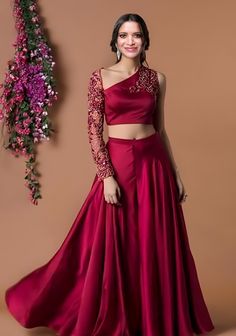 Crop Tops With Lehenga, Blouse With Belt For Lehenga, One Shoulder Blouse Designs For Lehenga, Red Crop Top Lehenga Party Wear, Blouse Design For Lehenga Crop Tops, Lengha Crop Top Blouse Designs, Lehenga With Crop Top Style, Sleeves Design For Crop Top, Off Shoulder Gown Design