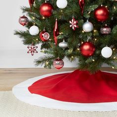 a small christmas tree with red and white ornaments