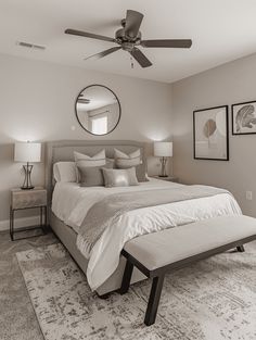 a bedroom with a large bed and ceiling fan