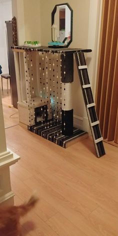 a room with a ladder, mirror and other items on the floor in front of it