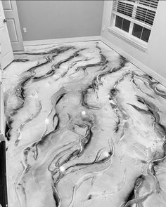 the floor in this bathroom is made out of marble and has been painted black and white