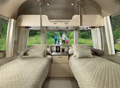 the inside of a camper with two beds in it