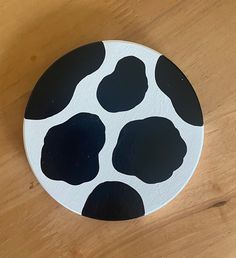 a black and white plate sitting on top of a wooden table