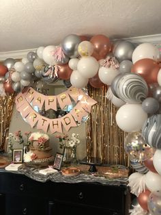 a birthday party with balloons, cake and decorations