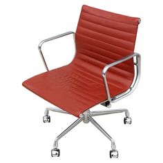 a red office chair with chrome legs and casteors on an isolated white background, viewed from the front