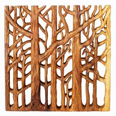 a wooden panel with trees carved into it