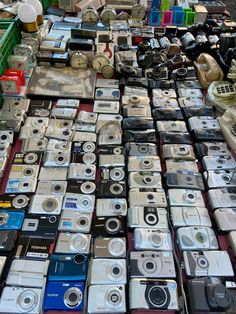 there are many different types of cameras on the table together in this market place,