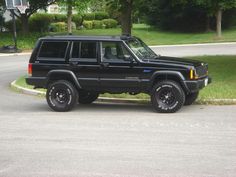 a black jeep is parked on the street