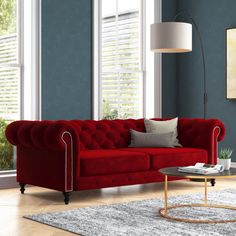 a living room with blue walls and red couches