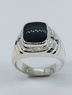 This elegant, Onyx Signet Ring has been carefully handcrafted in solid 925 sterling silver, Sapphire and authentic onyx.  This impressive ring is great for any occasion! buy it for someone special or buy it for your-self! Once ring has been shipped a tracking number will be provided to you.   Ring is size 10  but it can be resized at no extra cost and it will be shipped to you in an elegant gift box. Ring weights 8.3 grams Face of the ring is: 16.10 mm Ring Band is: 3.96 mm Onyx Measurement : 12 Ring Men Silver, Onyx Rings, Onyx Ring Men, Onyx Signet Ring, Under Lock And Key, Rome Antique, Ring Sapphire, Box Ring, Signet Rings