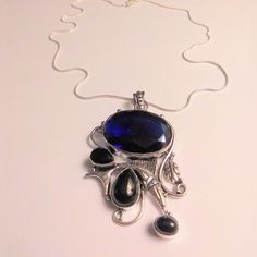 Stunning Edwardian Vintage Midcentury Avant-Garde Victorian Boho Style 925 Sterling Silver Ring 20 Inches N Chain Length 2.0 Inches N Pendant Length 42 Carats Of Tanzanite Stones 6 Carats Of Black Onyx Stones Tanzanite Is A Transformative Gemstone That Facilitates Inner Calm, Dissolves Old Patterns, And Stimulates Psychic Abilities And Higher Consciousness. 100% Authentic Stones, 925 Sterling Silver. This Will Be A Nice Addition To Your Jewelry Collection. Thanks For Dropping In An Checking My C Victorian Boho, Old Patterns, Tanzanite Stone, Black Onyx Stone, Higher Consciousness, Onyx Stone, Psychic Abilities, Sterling Silver Necklace, Tanzania