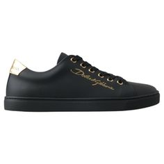 Step Into Luxury With These Stunning, Brand New Classic Sneakers From The Iconic Fashion House Dolce & Gabbana. Crafted From Premium 100% Leather In A Sleek Black With Gold Accents, These Shoes Are Not Just A Statement Of Style, But A Testament To Italian Craftsmanship. The Durable Rubber Sole Ensures Comfort And Longevity, While The Distinctive Logo Detail Adds An Exclusive Touch To Your Every Step. Elegance Meets Street Style With These Luxurious Sneakers, Made In Italy. Material: 100% Leather Luxury Gold Sneakers With Rubber Sole, Luxury Leather Sneakers With Metallic Logo, Luxury Calf Leather Sneakers With Logo Plaque, Luxury Black Lace-up Sneakers, Luxury Leather Sneakers With Logo Plaque, Designer Black Sneakers With Logo Plaque, Luxury Calf Leather Sneakers, Luxury Calf Leather Sneakers For Formal Occasions, Elegant Low-top Calf Leather Sneakers