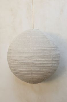 a white paper ball hanging from a string