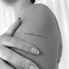 a woman's arm with the words breathe within her