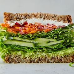 a sandwich with lettuce, carrots and other vegetables on top of it