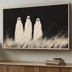 three ghost figures standing in the grass on a black and white background framed art print