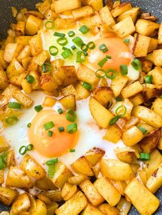 an egg is on top of potatoes in a skillet