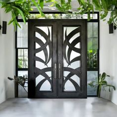 an entrance with two doors and some plants