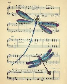 three dragonflies sitting on top of sheet music