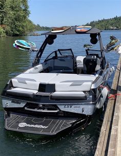 a white and black boat parked next to a dock