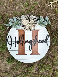 a wooden sign with the letter h on it