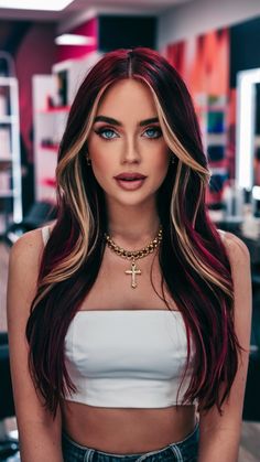 Long, dark red hair is elevated with blonde highlights that frame the face. This dynamic color pattern adds depth and brightness, creating an elegant yet bold aesthetic for those who love contrasts. Burgundy Hair With Money Piece, Long Dark Red Hair, Cherry Red Hair With Blonde Highlights, Hair Colors With Highlights, Red And Blonde Highlights, Red Hair Streaks, Strawberry Highlights, Red Hair With Blonde, Brunette Shades