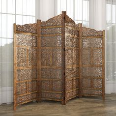 a room divider made out of wood with intricate carvings