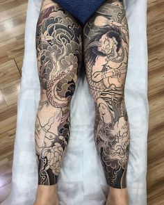 a person laying on top of a bed covered in lots of tattooed leg sleeves and legs