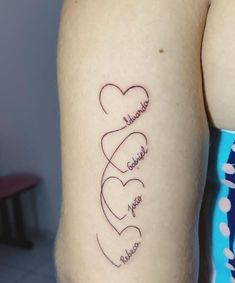 two hearts with names tattooed on the arm