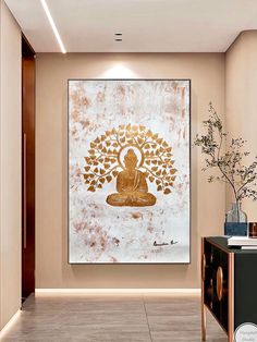 a buddha statue sitting under a golden tree on a white and gold wall in a room