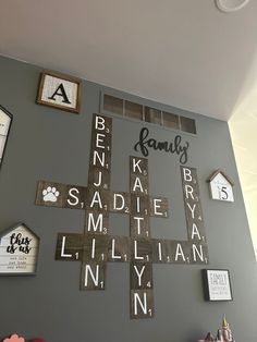 the wall is decorated with wooden letters and frames that spell out family's names