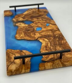 a piece of art made out of wood and blue paint on the bottom half of it