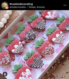 decorated heart shaped cookies in a box on a table